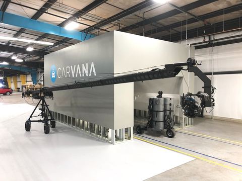 Crane — remote head on a wheeled dolly in an industrial space.