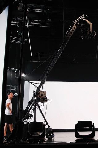 Jib — rig on its wheeled base, operator beside it.