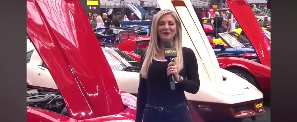 Mecum Auction (2025) — Jib. A presenter at the cars on the block.